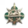 Insigne du 601e régiment de circulation routière, illustré d'un trèfle vert, d’une roue dentée, d’un lion couché...