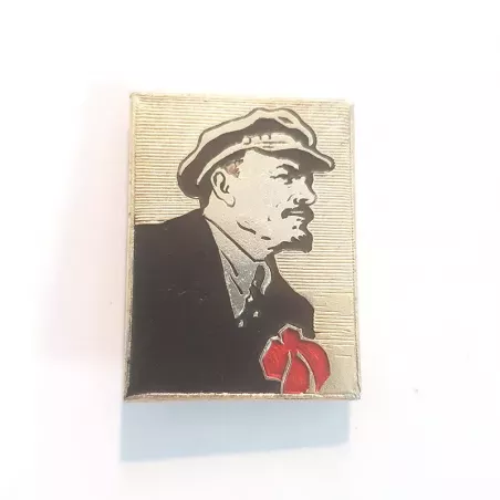 Pin's rectangulaire représentant Lénine vêtue d'un costume noir avec une fleur rouge posée sur le cœur.