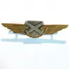 Brevet personnel non navigant de l'ALAT, formé d'un écu, de 2 cannons croisés et d'ailes.